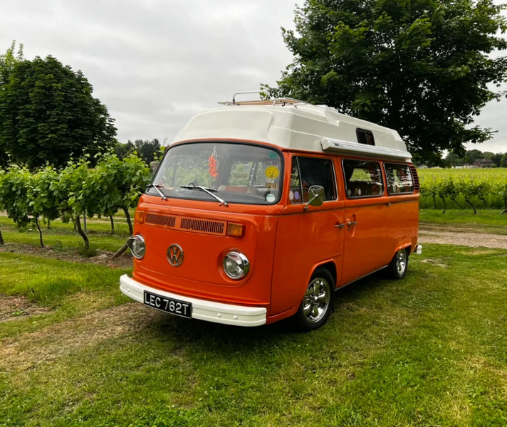 One Bright Orange and Beige 1979 High Top VW Campervan